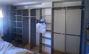 Dust grey wardrobe going from wall to wall with lots of haning and shelves, fitted in Billingham